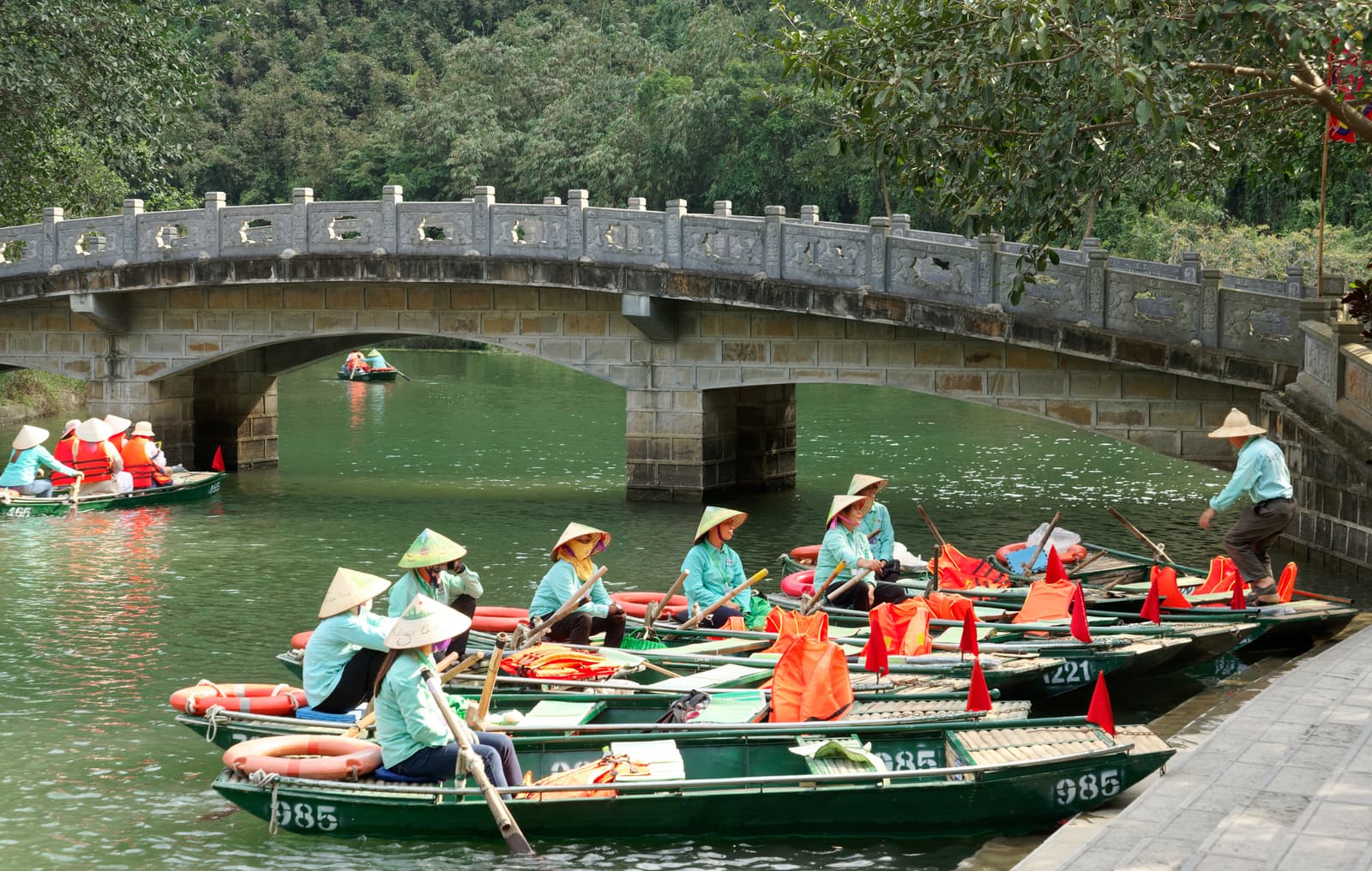 Rowing boats on the river among the karst cliffs of Trang An