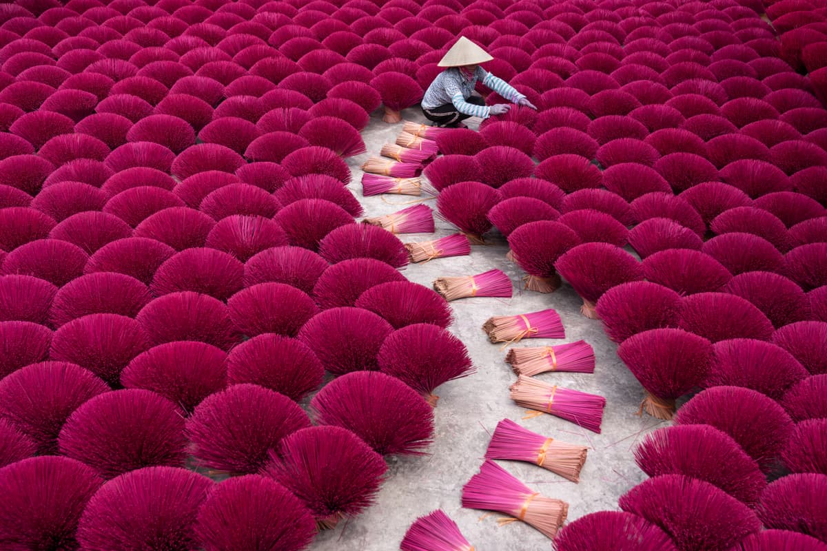 Bundles of red incense sticks drying in a craft village