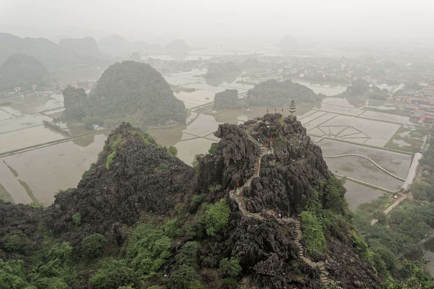 The view over rice fields and karst peaks from the top of Mua Cave
